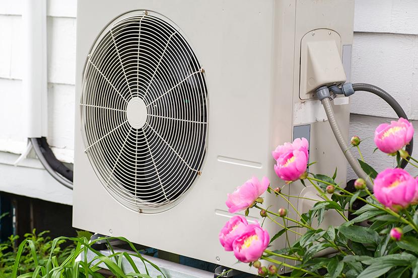 air conditioning heat pump unit on side of a home